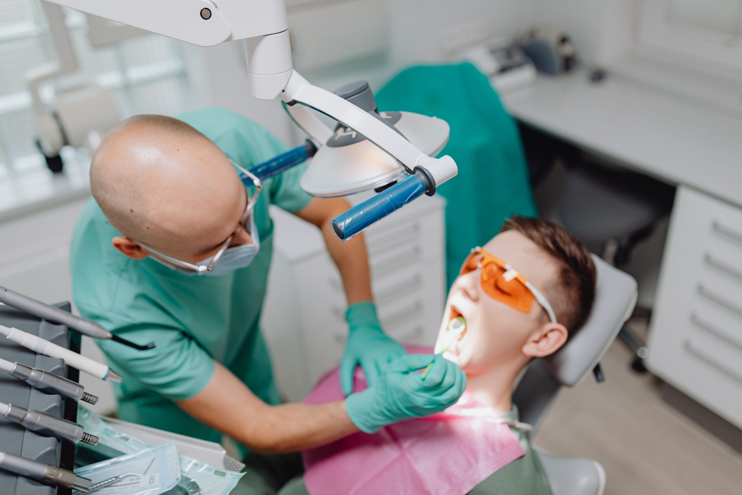 Our Services Dentist performing oral examination with patient in modern dental clinic.