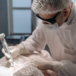 A focused surgeon performs laser surgery in a sterile operating room, emphasizing precision and care.